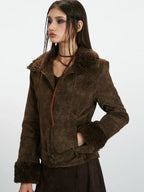 Woman showing the pocket of a brown faux suede jacket with shearling trim.