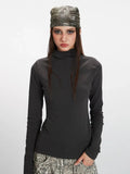 Full body shot of a model showcasing the fitted silhouette of the long sleeve top.