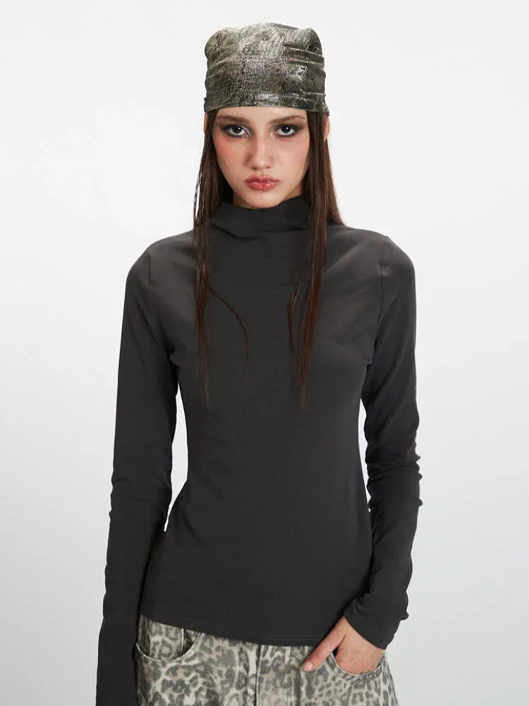 Full body shot of a model showcasing the fitted silhouette of the long sleeve top.