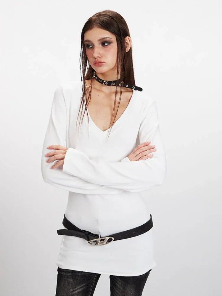 Close-up of a model wearing a white long-sleeve V-neck top and a black choker necklace.