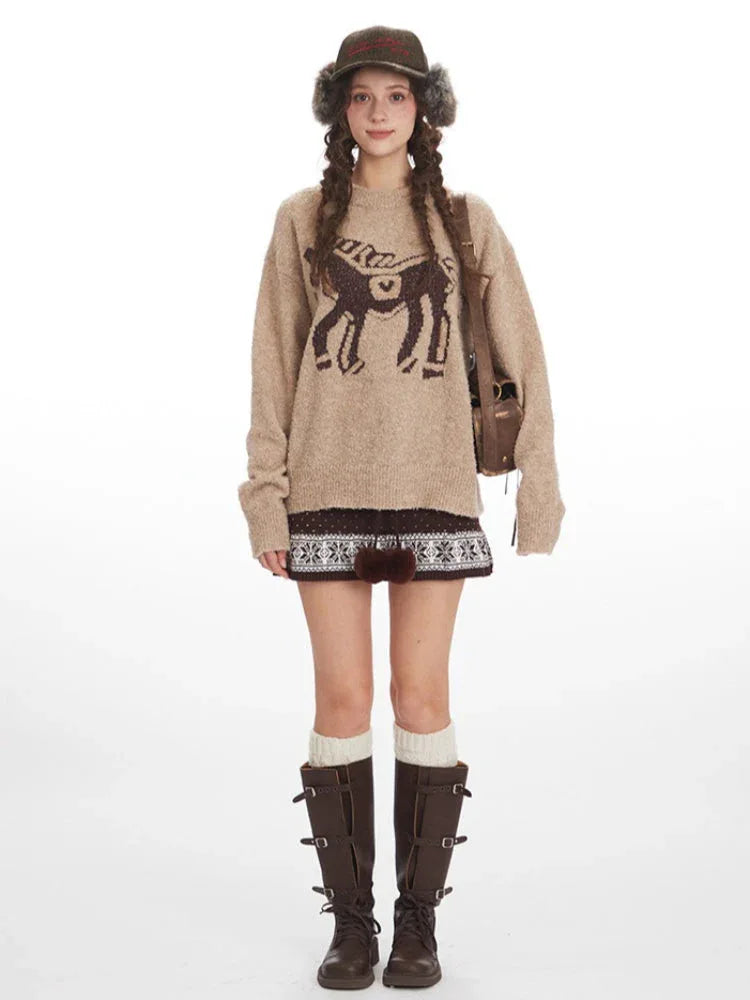 Woman wearing a tan knit sweater with a brown intarsia horse graphic on the front. Main image