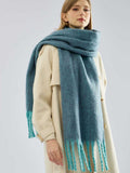 Close-up of a blue knit scarf with fringed edges