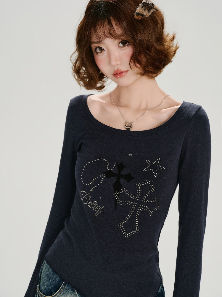 Full body shot of a woman in a dark blue long-sleeve graphic t-shirt and distressed jeans