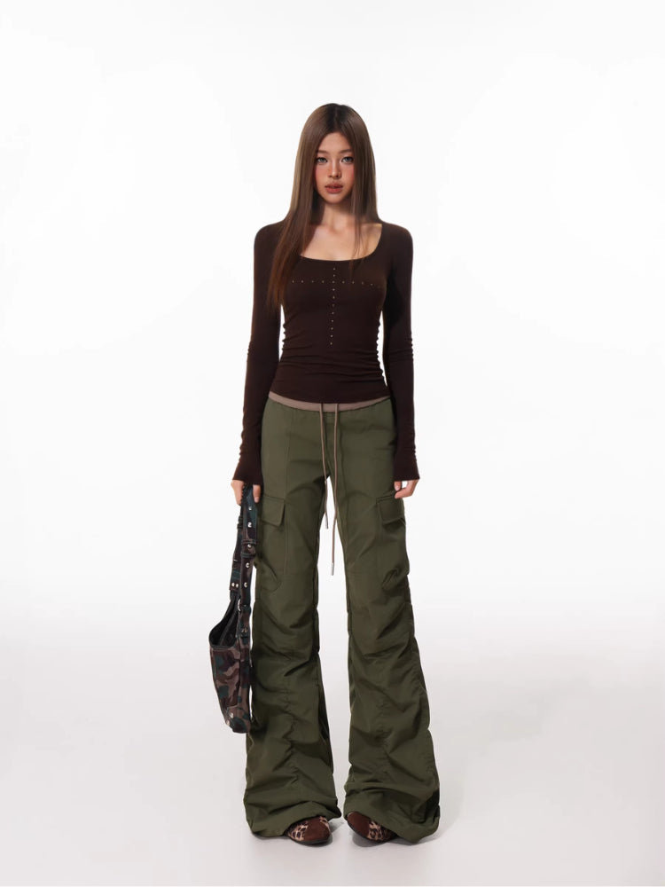 Full body shot of model wearing the brown long-sleeve top and cargo pants