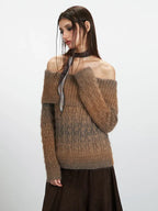 Model posing in a brown and grey gradient off-the-shoulder knit sweater.