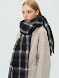 Close-up of a woman wearing a black and white plaid scarf