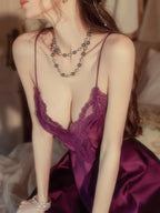 Front view detail of a woman's upper body in a purple satin babydoll with lace trim.