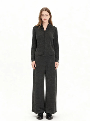 Woman wearing a charcoal grey knit loungewear set with a full zip jacket and wide leg pants, front view.