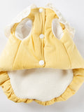 Inside view of a yellow pet vest showing button closures and fleece lining