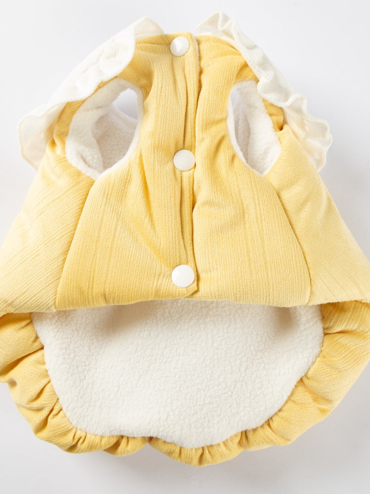 Inside view of a yellow pet vest showing button closures and fleece lining