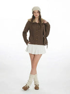 Front view of a woman in a brown knit cardigan with a fur collar.