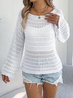 Back view of a woman in a white hollow out knit sweater