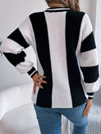 Back view of a woman in a black and white striped knit sweater.