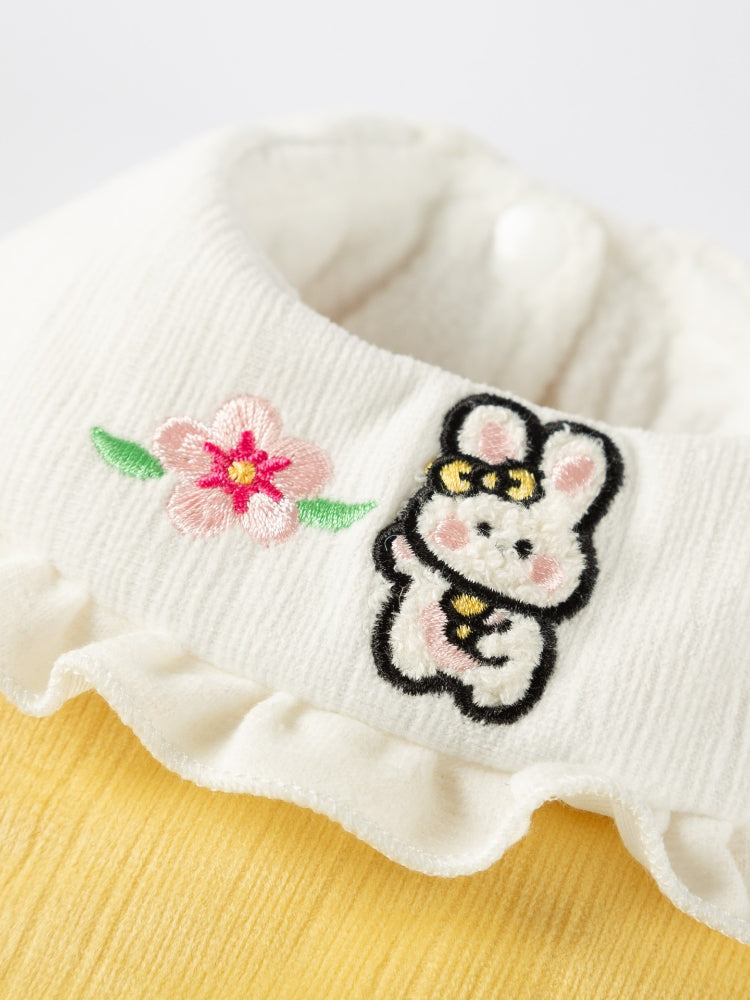 Detailed view of the embroidered bunny and flower on the pet vest collar