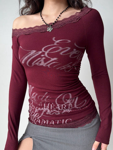 Burgundy long sleeve off-the-shoulder top with lace trim and graphic print