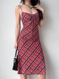 woman posing in a red and pink plaid mesh midi dress