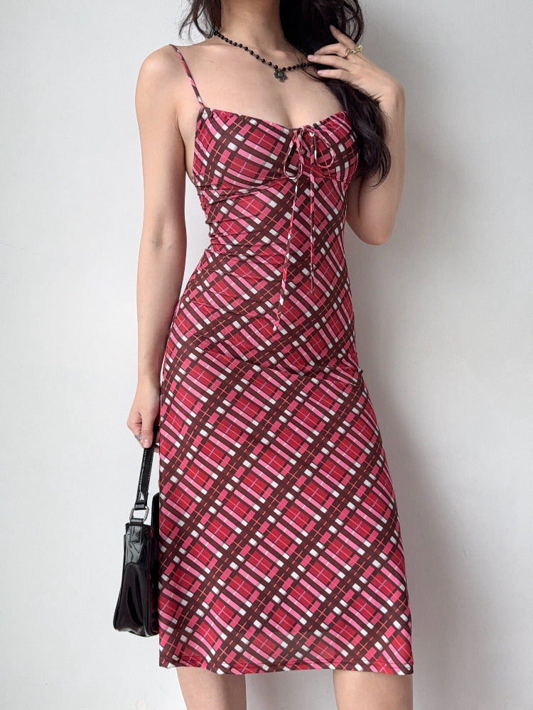 woman posing in a red and pink plaid mesh midi dress