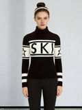 Woman wearing a black and white knit turtleneck sweater with 'SKI' graphic and star details