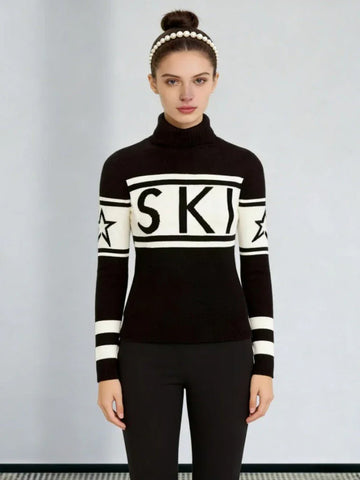 Woman wearing a black and white knit turtleneck sweater with 'SKI' graphic and star details