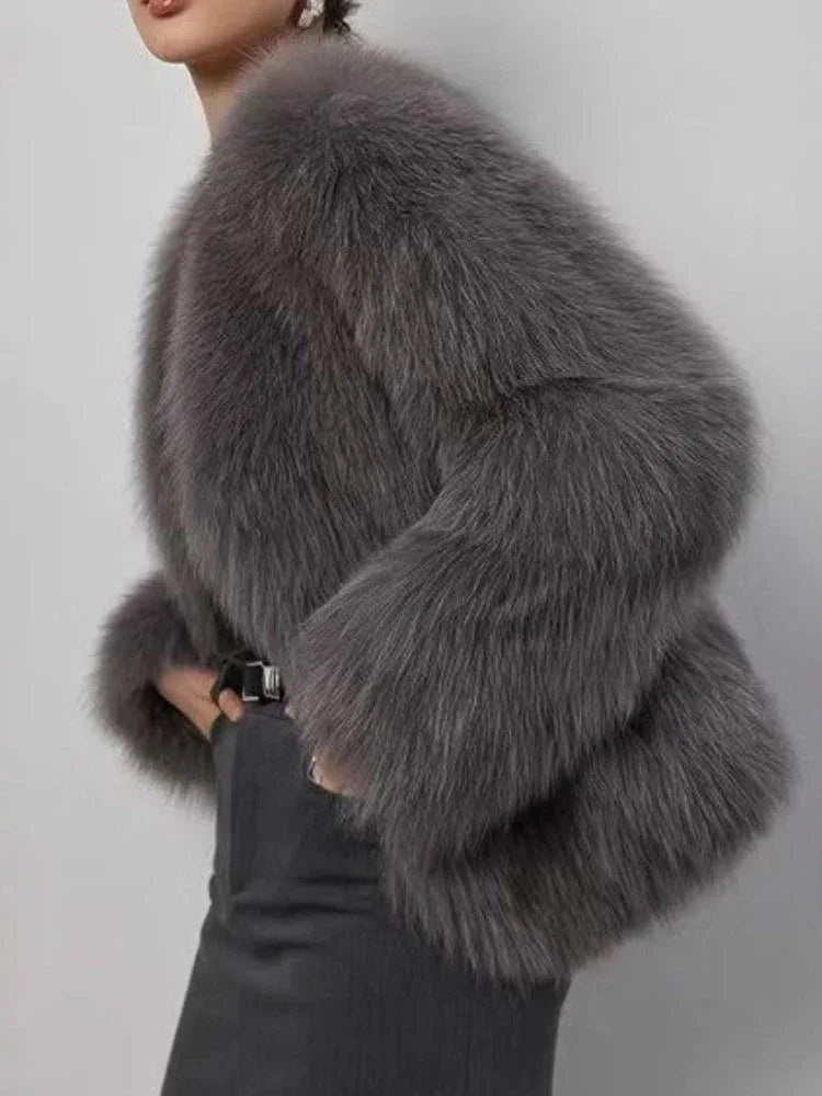 Back view of a woman in a grey fluffy faux fur jacket.