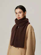 Woman wearing a dark brown ribbed knit scarf