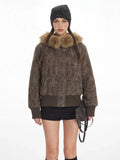 Front view of a woman in a textured brown bomber jacket