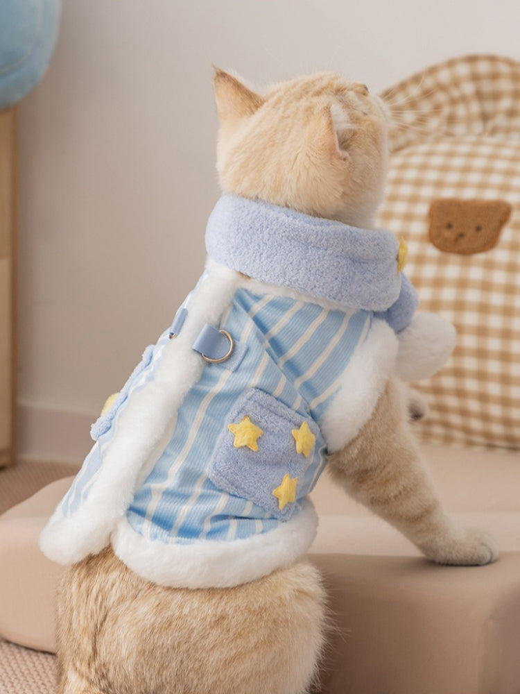 Rear view of a cat wearing a blue and white striped vest with faux fur trim and yellow star appliques.