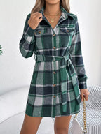 Front view of a green plaid long-sleeve shirt dress with button details.