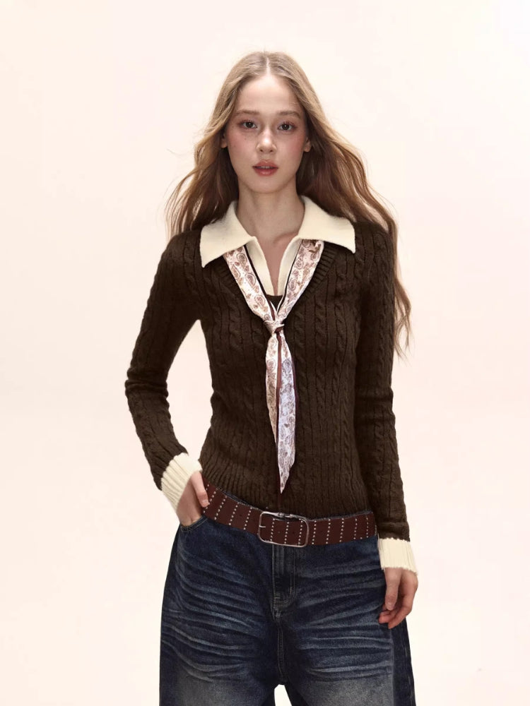 Woman wearing a brown cable knit collared sweater with a white collar and cuffs, paired with dark wash wide-leg jeans and a patterned scarf.