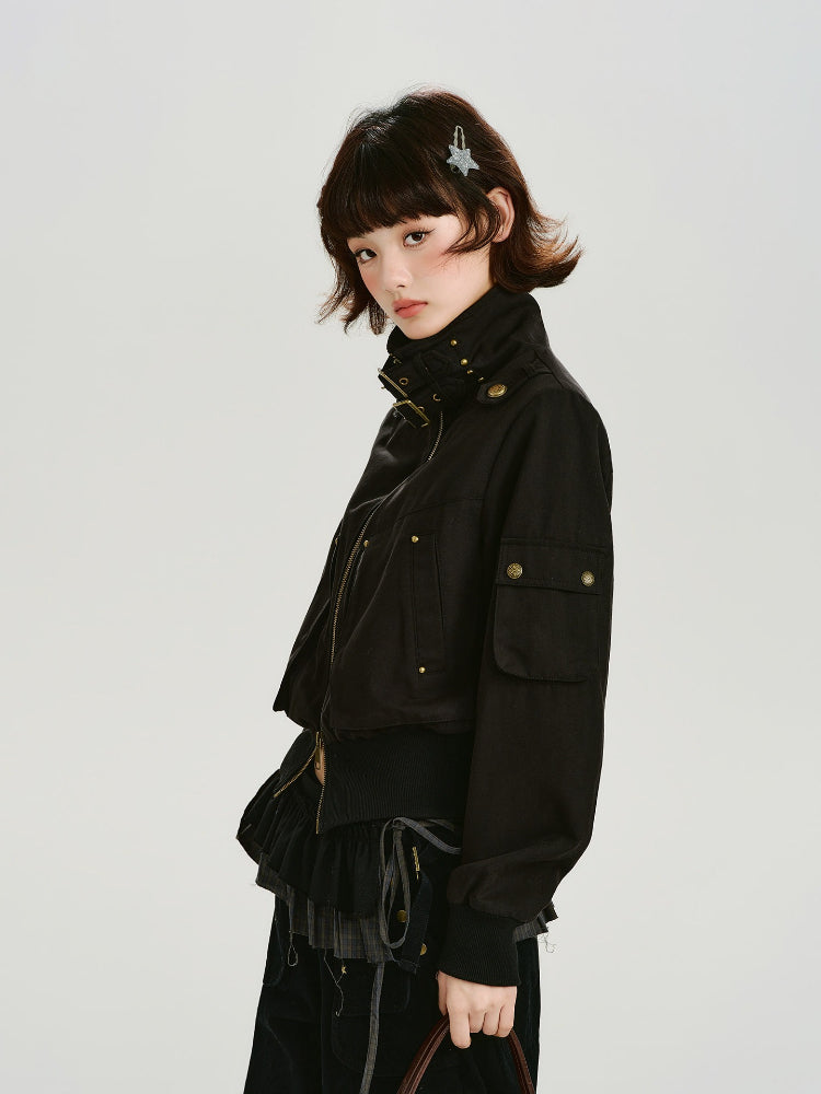 Woman wearing a black bomber jacket with gold hardware