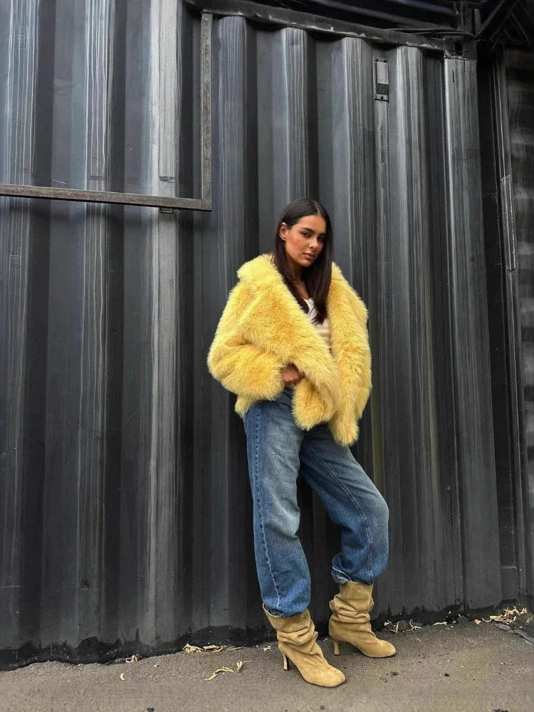 Woman in a yellow faux fur jacket and baggy blue jeans