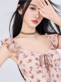 Close-up of the square neckline and tie front detail on a pink floral dress