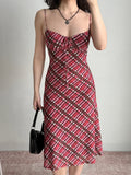 full body shot of a woman wearing a red and pink plaid mesh midi dress