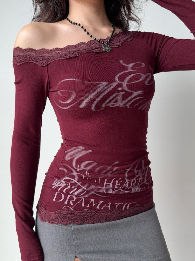 Model wearing a fitted burgundy long sleeve top with lace detailing at the neckline and hem