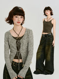 Model wearing a dark olive green halter neck crop top layered under a grey ribbed knit cardigan.
