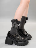 A person wearing gray crew socks with a gray flower embellishment and bow detail, paired with platform Mary Jane shoes.
