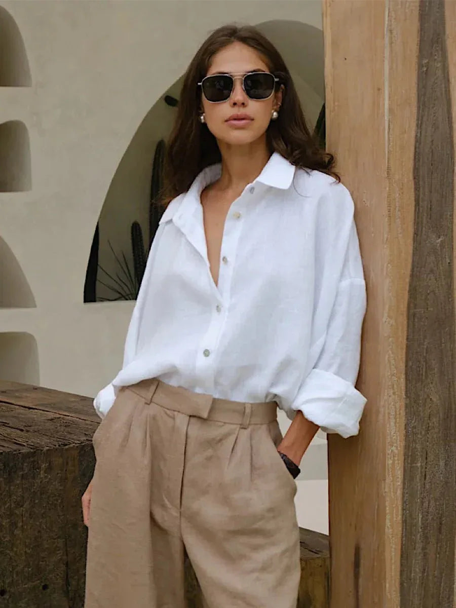 Model wearing a white oversized cotton shirt with beige trousers