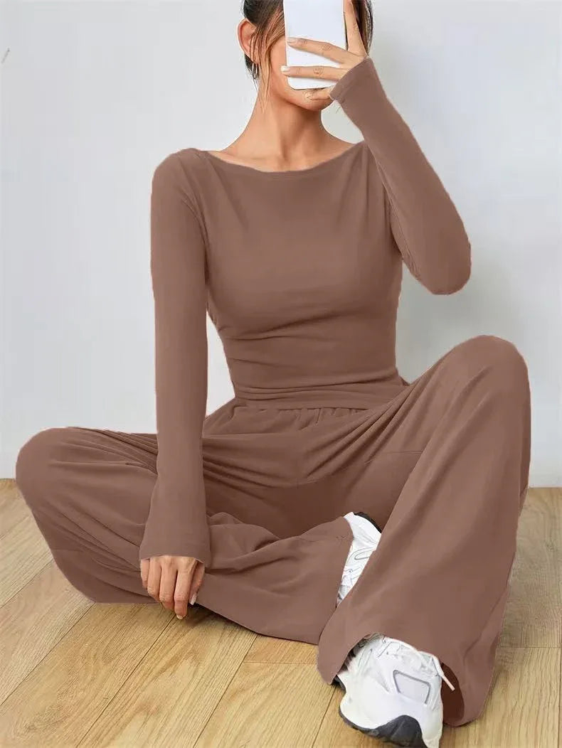 Woman sitting down wearing a brown boat neck loungewear set