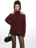 Close-up of the neckline on a burgundy cold shoulder halter neck sweater
