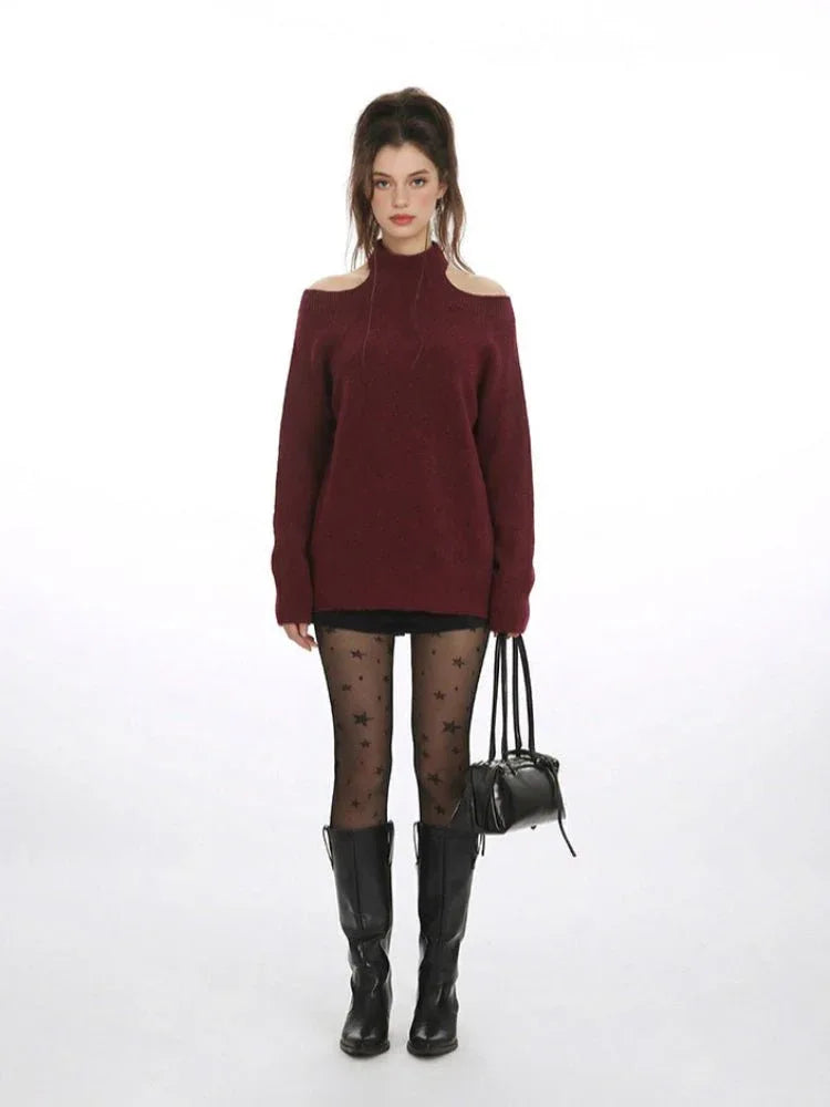 Woman wearing a burgundy cold shoulder halter neck sweater