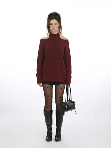 Woman wearing a burgundy cold shoulder halter neck sweater