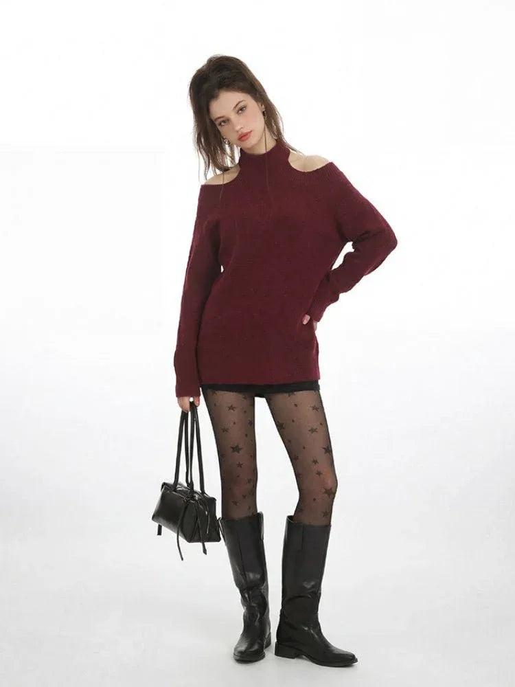Front view of a woman in a burgundy cold shoulder halter neck sweater