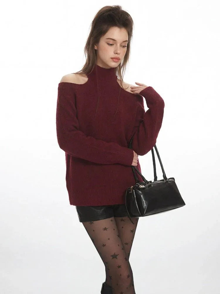 Woman posing with a burgundy cold shoulder halter neck sweater