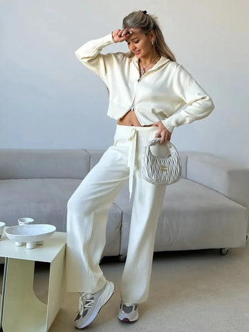 Woman wearing ivory white knit set with double zip cardigan and wide leg pants