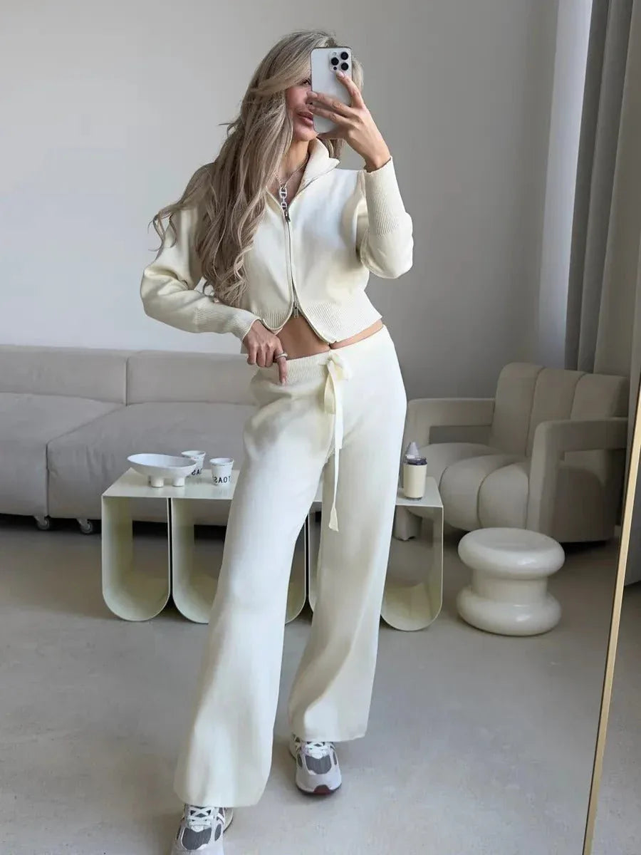 Woman in pink knit set with double zip cardigan and wide leg pants