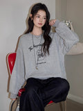 Detail of the ribbed neckline and cuffs on an oversized sweatshirt