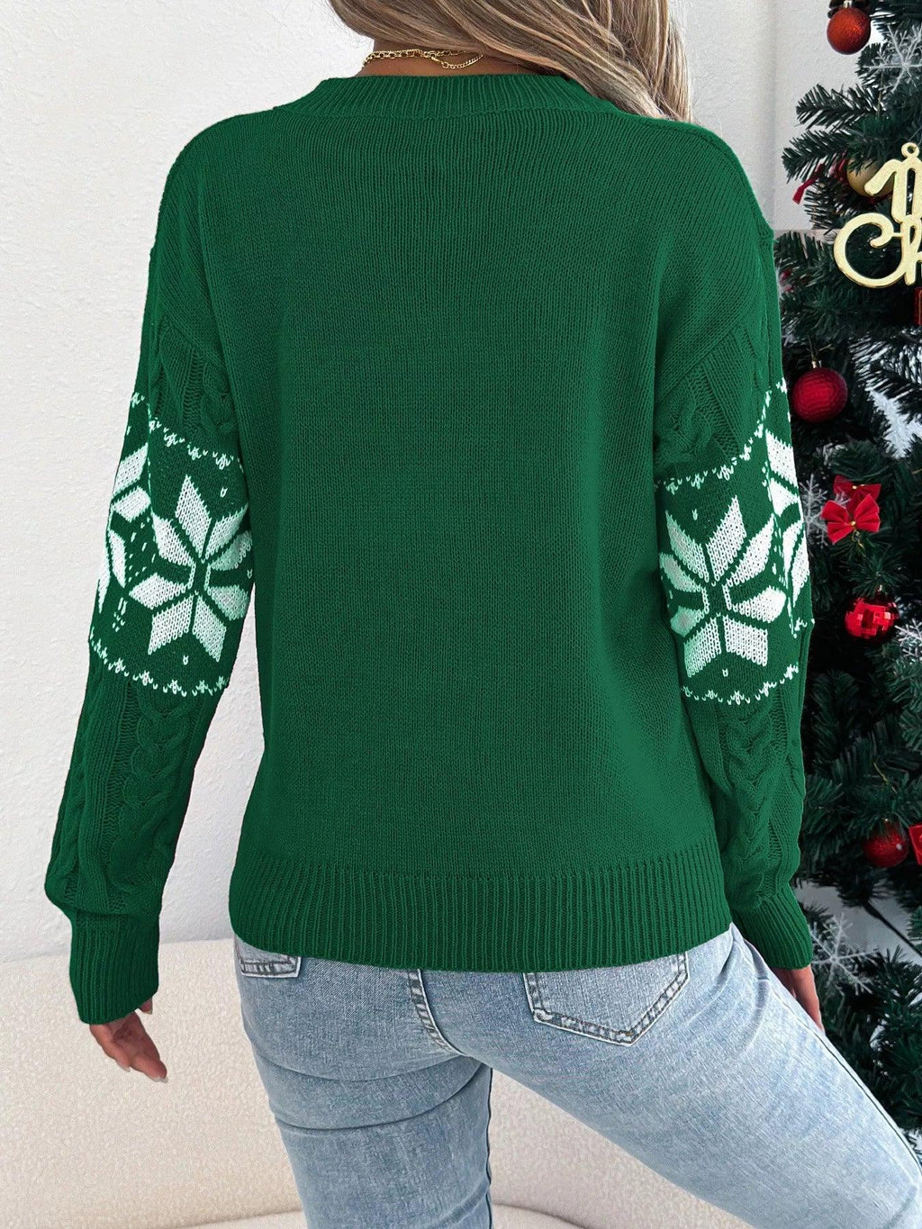 Back view of a green snowflake intarsia sweater