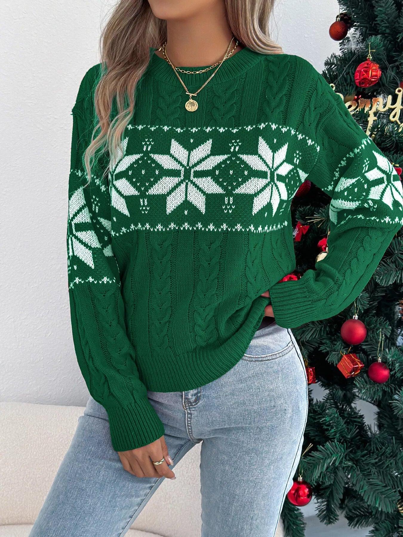 Woman wearing a green cable knit sweater with white snowflakes