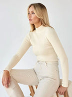 Side profile of a woman in a ribbed mock neck top
