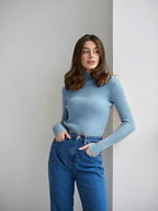 Woman wearing a white ribbed mock neck sweater - View 38 | WEUXS